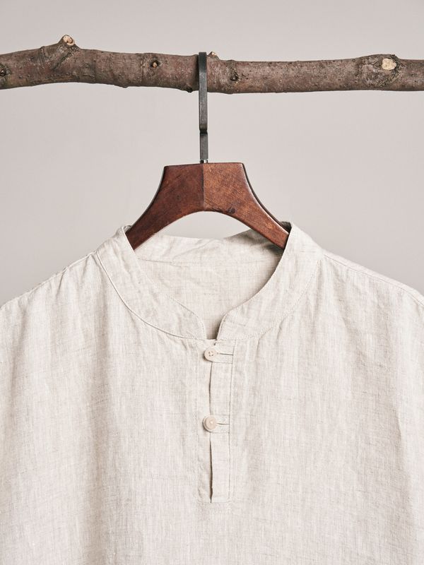 A linen shirt on a wooden hanger